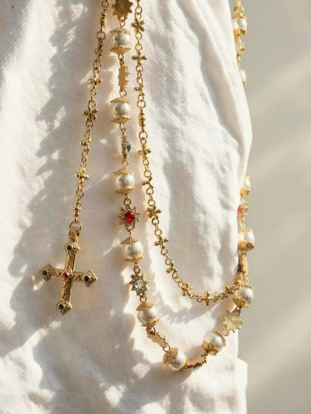 Y2k 2000s style gold chain belt with faux pearls and cross pendant
